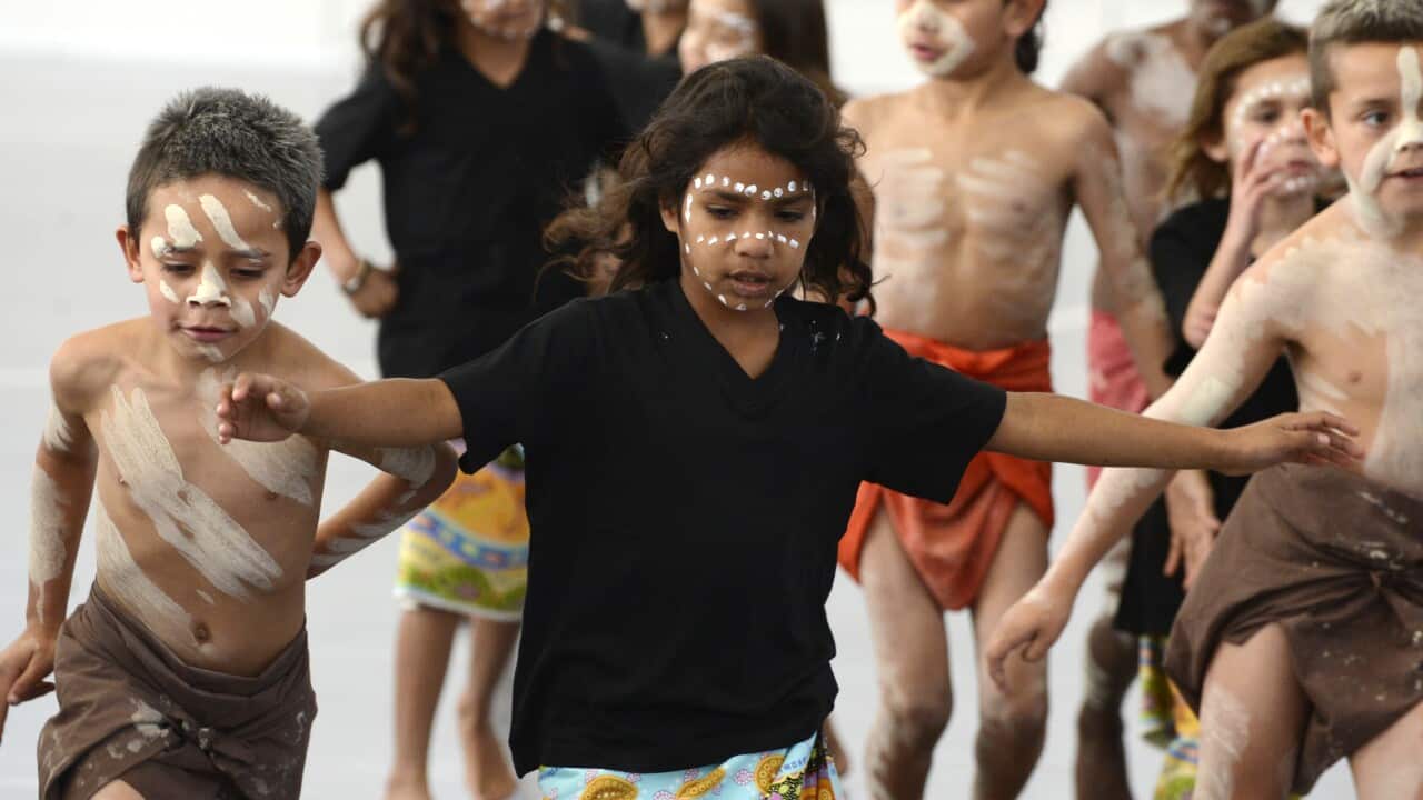 Indigenous schoolchildren dance during a launch of the National Aboriginal and Torres Strait Islander Health Plan in Brisbane.