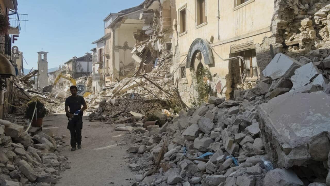 A man walks in a street in Amatrice, central Italy