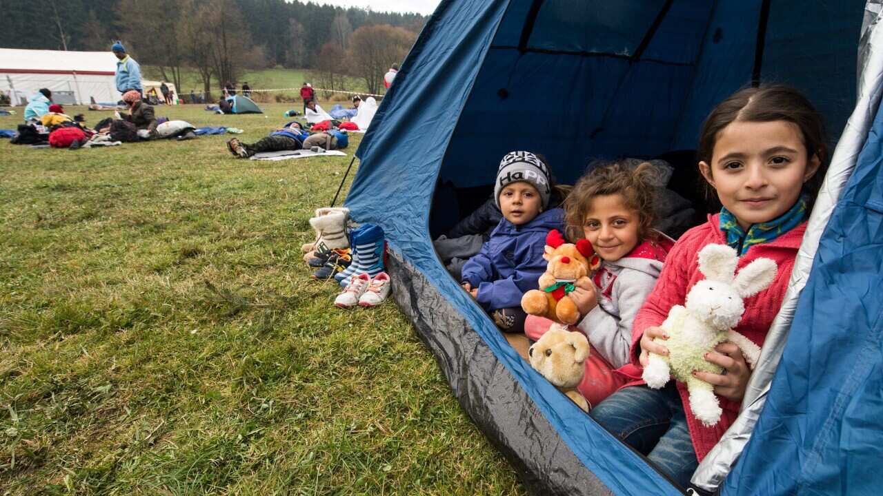 Syrian refugee children sit in a tent near Hanging at the German-Austrian border in Hanging, Austria,