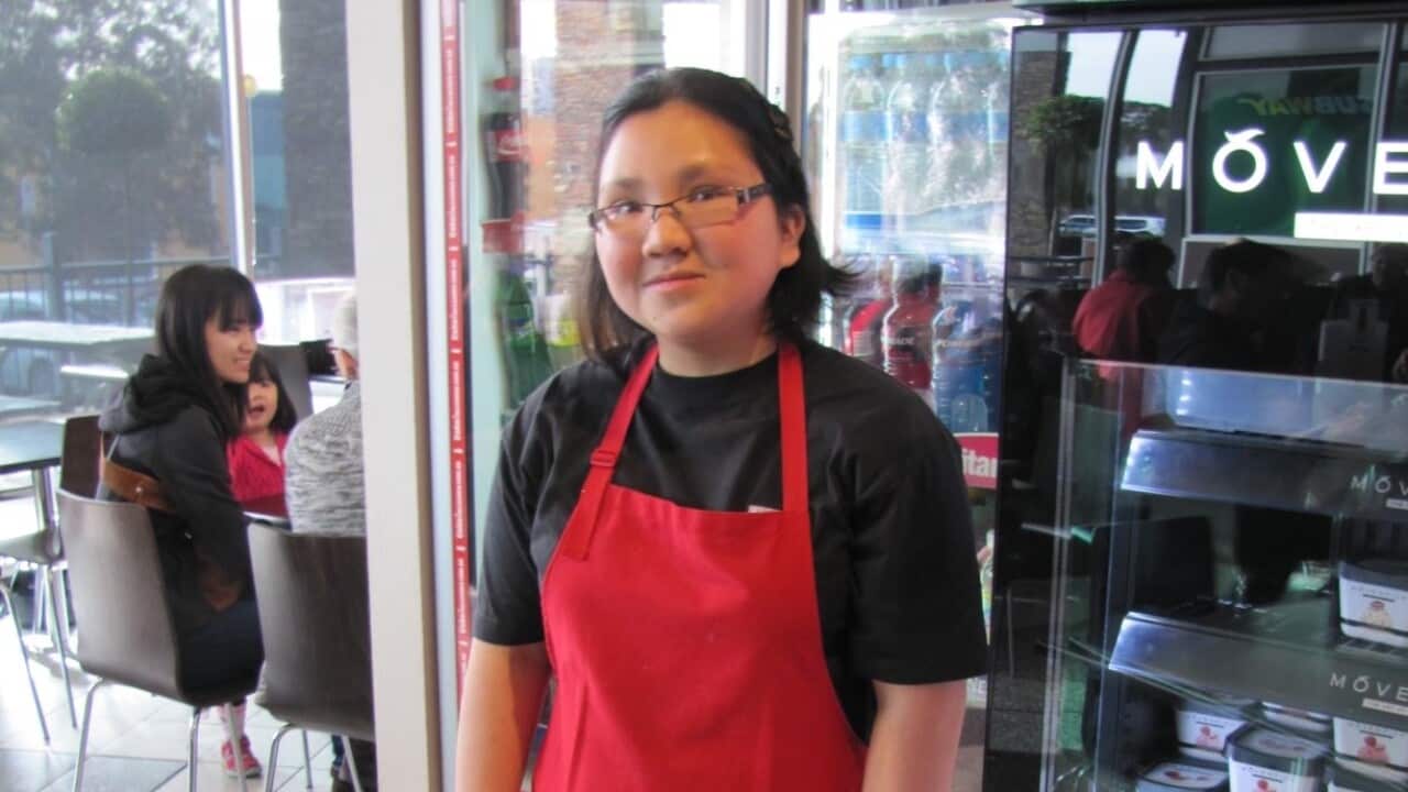 Aileen Ng standing in front of the Indulgence Cafe in Doncaster where she works.