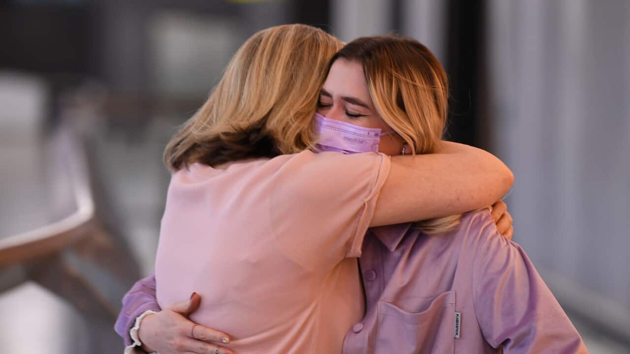 A family is reunited in international arrivals terminal at Tullamarine Airport in Melbourne.