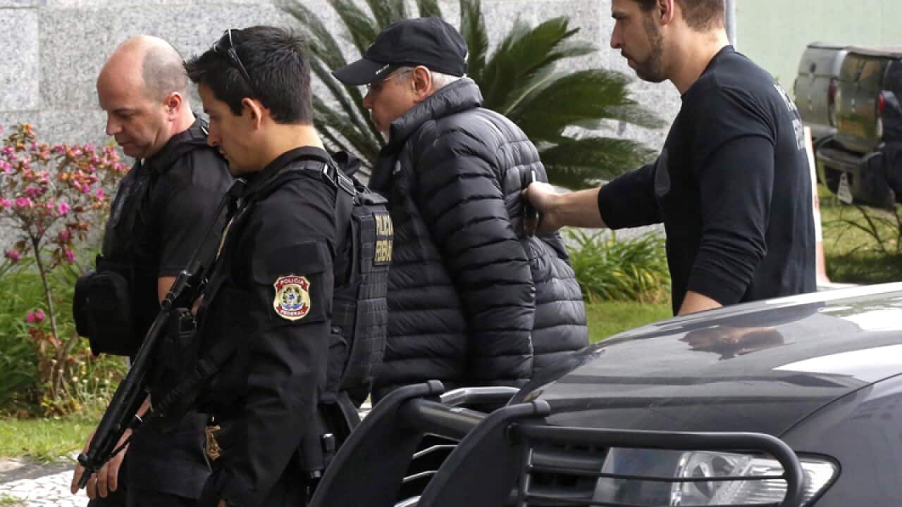 Former Brazilian Finance Minister Guido Mantega (2R) is arrested