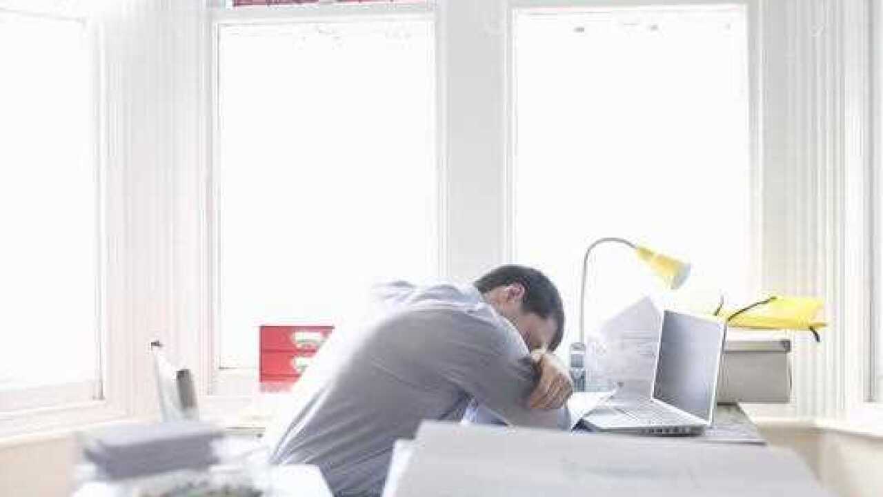 adult man sleeps at his desk