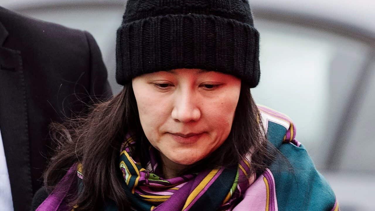 Huawei chief financial officer Meng Wanzhou arrives at a parole office with a security guard in Vancouver, British Columbia, 12/12/18.