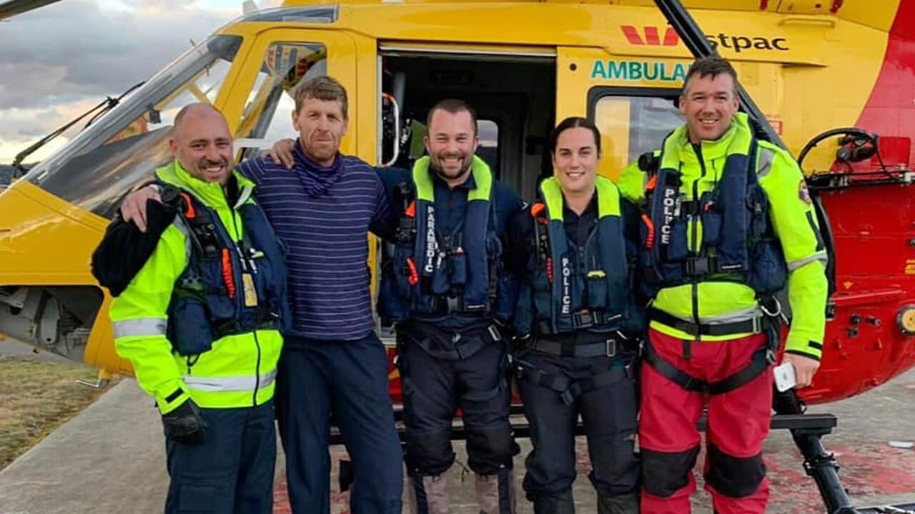 57-year-old bushwalker Michael Bowman (second left) after being rescued from the Lake St Clair region in Tasmania, Tuesday, July 16, 2019.