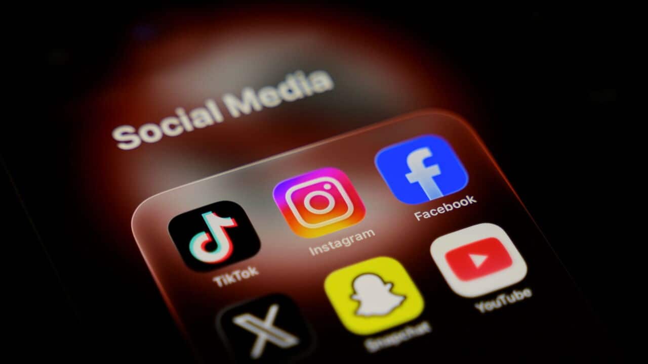 A smartphone displays a folder of social media applications, including TikTok, Instagram, Facebook, X, Snapchat, and YouTube (Samuel Boivin-NurPhoto via Getty Images).