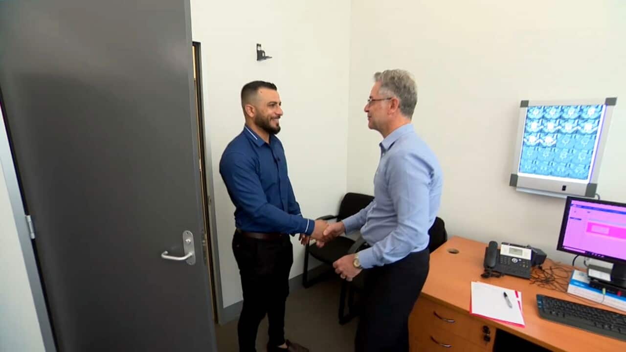 Dr John Best greets a patient at the ICFAR facility