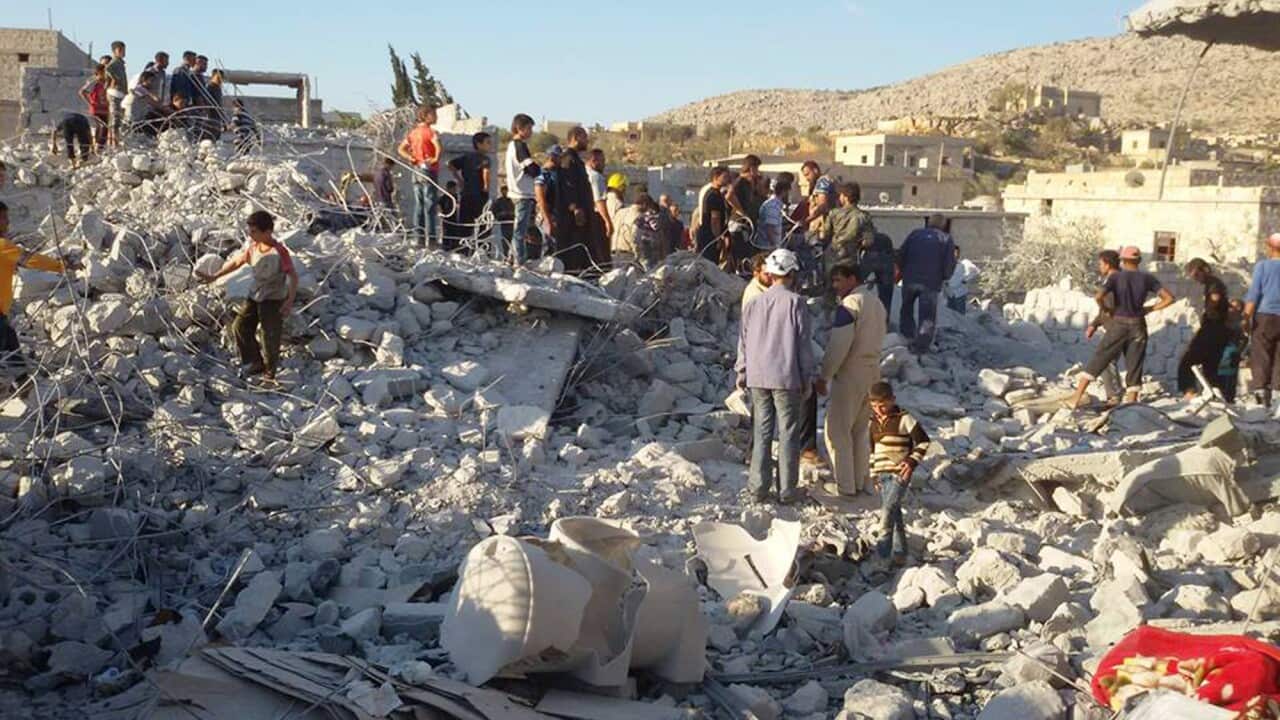 A photo by anti-Bashar Assad activist group Edlib News Network (ENN), which has been authenticated, shows Syrian citizens checking a damaged house that they say was targeted by the coalition airstrikes, in the village of Kfar Derian, a base for the al-Qai