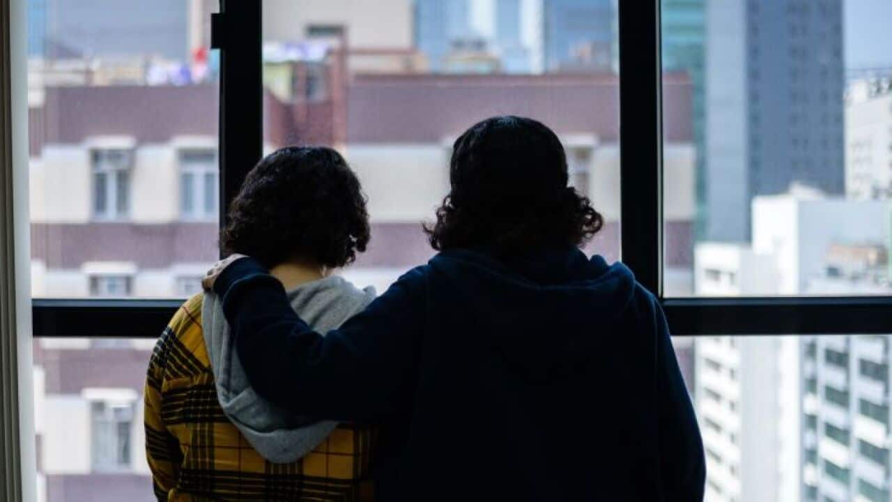 Saudi sisters Rawan (in yellow), 18, and Reem, 20, (both using adopted aliases) stand next to each other during an interview with AFP in Hong Kong.