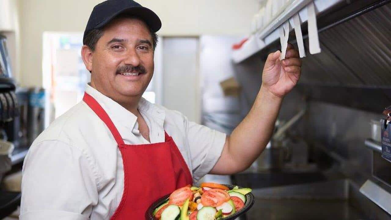 Portrait of man working in restaurant kitchen