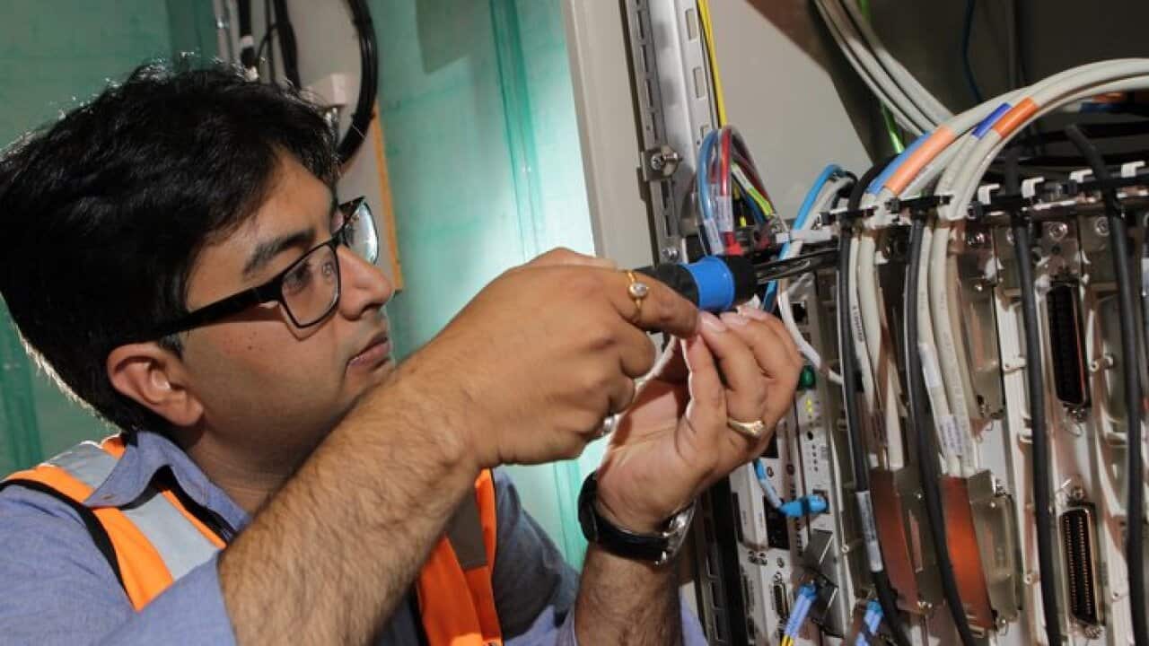 NBN technician Rajav Kapil connecting an apartment block to the National Broadband Network (NBN) in Brunswick, Melbourne, Tuesday, March 11, 2014. (AAP Image/David Crosling) NO ARCHIVING
