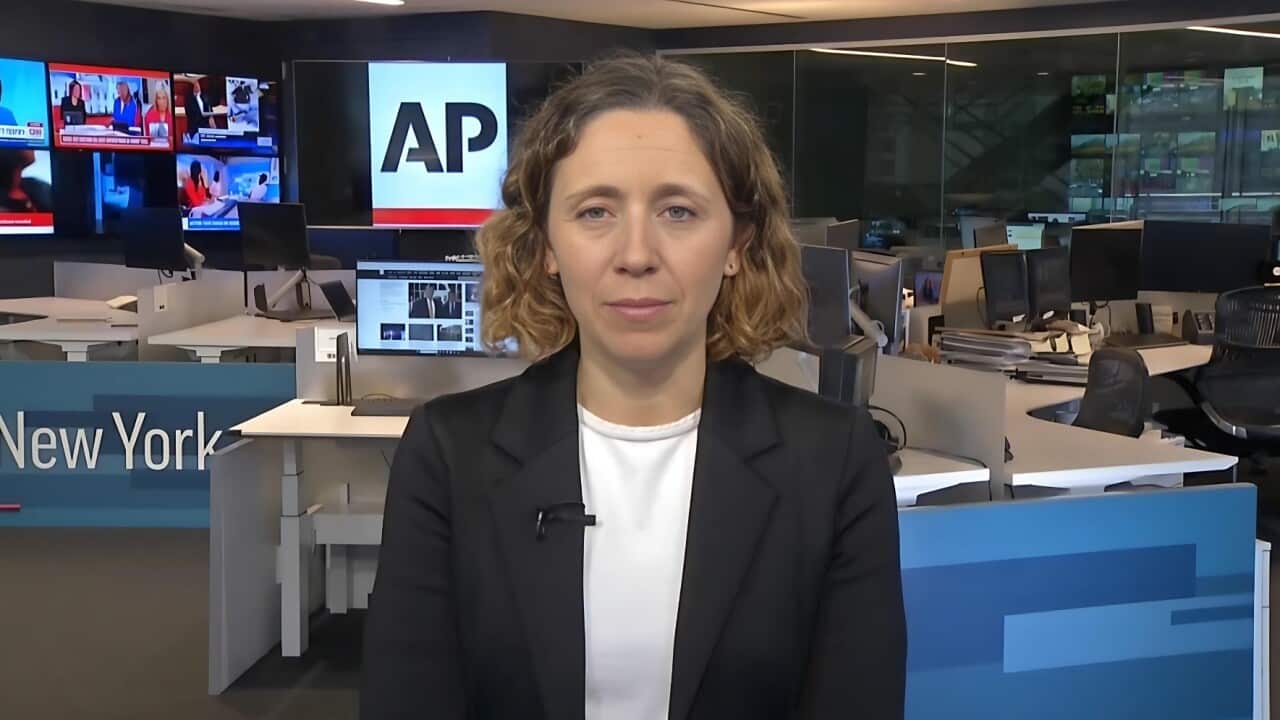 Associated Press Executive Editor Julie Pace in a black suit jacket in the newsroom.