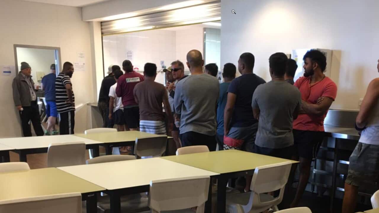 Asylum seekers in line to get food in Villawood detention center in Sydney.