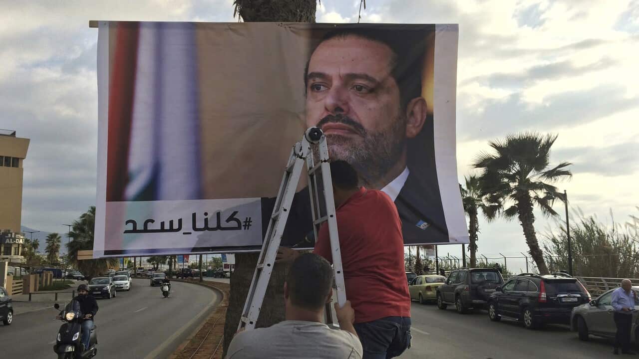A poster of outgoing Prime Minister Saad Hariri reads 'We are all Saad', in Beirut