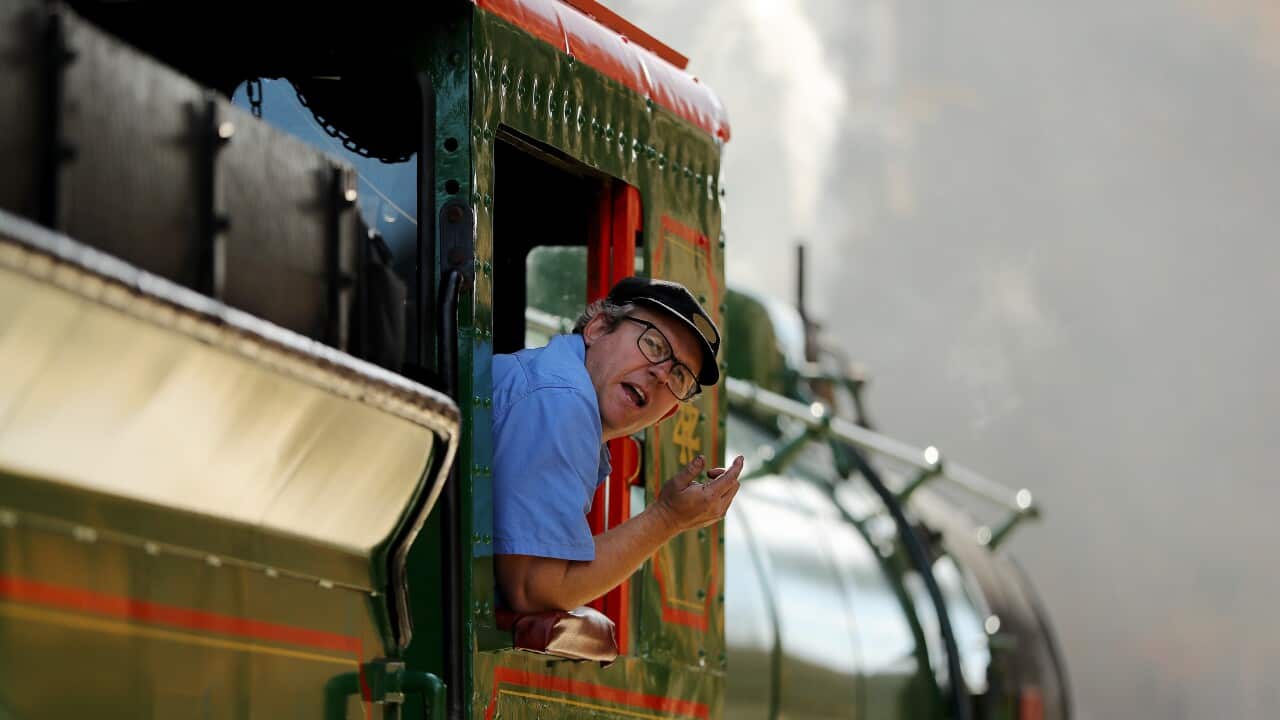 Driver Lee Wiggins instructs his colleague a he backs up the Locomotive 218A during the reopening of the historic Zig Zag Railway in Lithgow