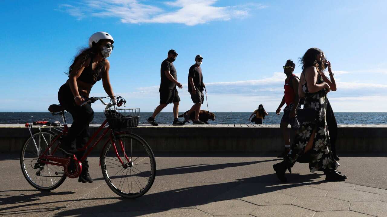 People walking and cycling along the St Kilda Beach Promenade in Melbourne, 28 October, 2020.