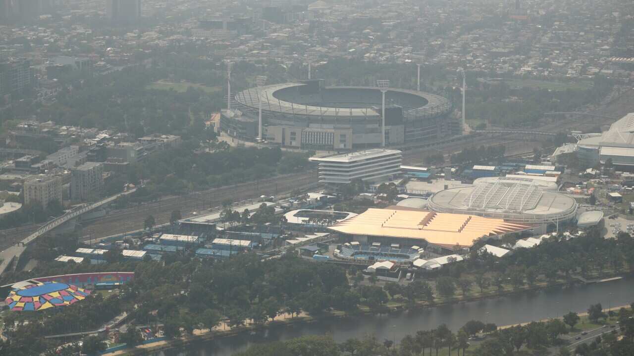 The Australian Tennis centre and MCG are seen from Eureka Tower as smoke haze from the bushfires continues to hang over Melbourne.