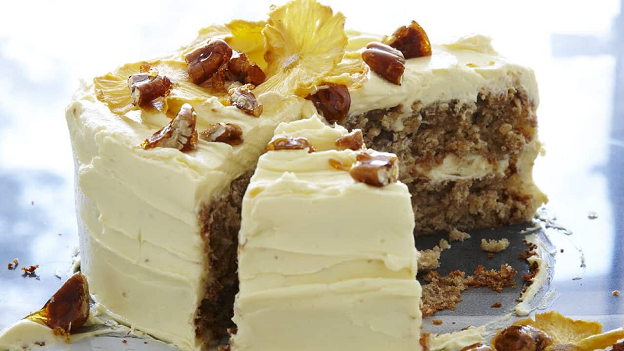 Hummingbird cake with cream cheese frosting, dried pineapple and toffee pecans