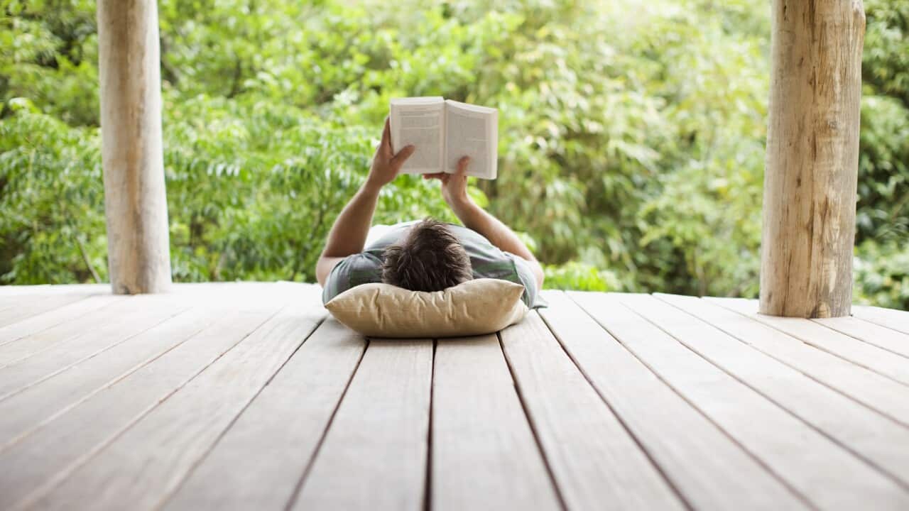 Man reading on porch in remote area