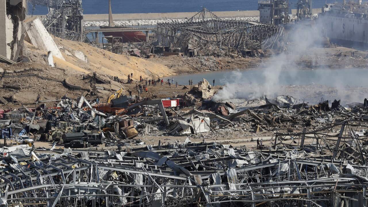 Rescue workers and security officers work at the scene of an explosion that hit the seaport of Beirut, Lebanon.