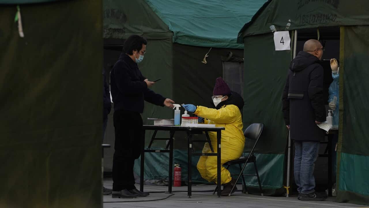 Residents line up for coronavirus tests at tents set up on the streets of Beijing.