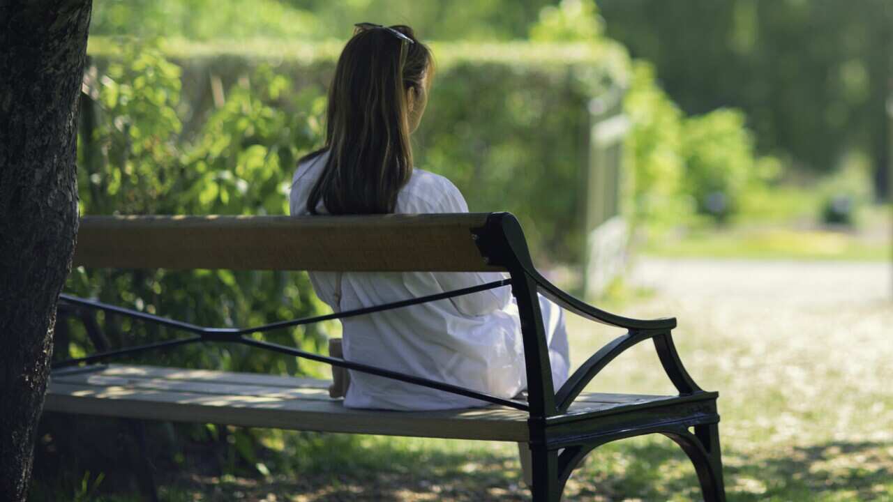 A woman relaxing in a green garden