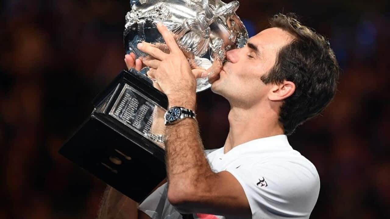 Roger Federer of Switzerland is seen with the mens trophy.