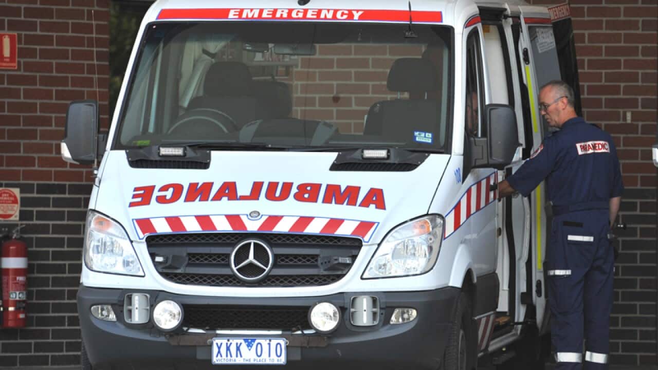 A paramedic loads an ambulances at the emergency department