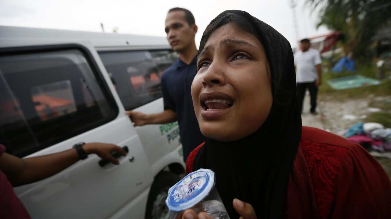 Somirahatun, a Myanmar migrant, reacts as she lost her baby during a journey at sea, at a temporary shelter in Kuala Langsa, Aceh, Indonesia, 16 May 2015. (EPA)