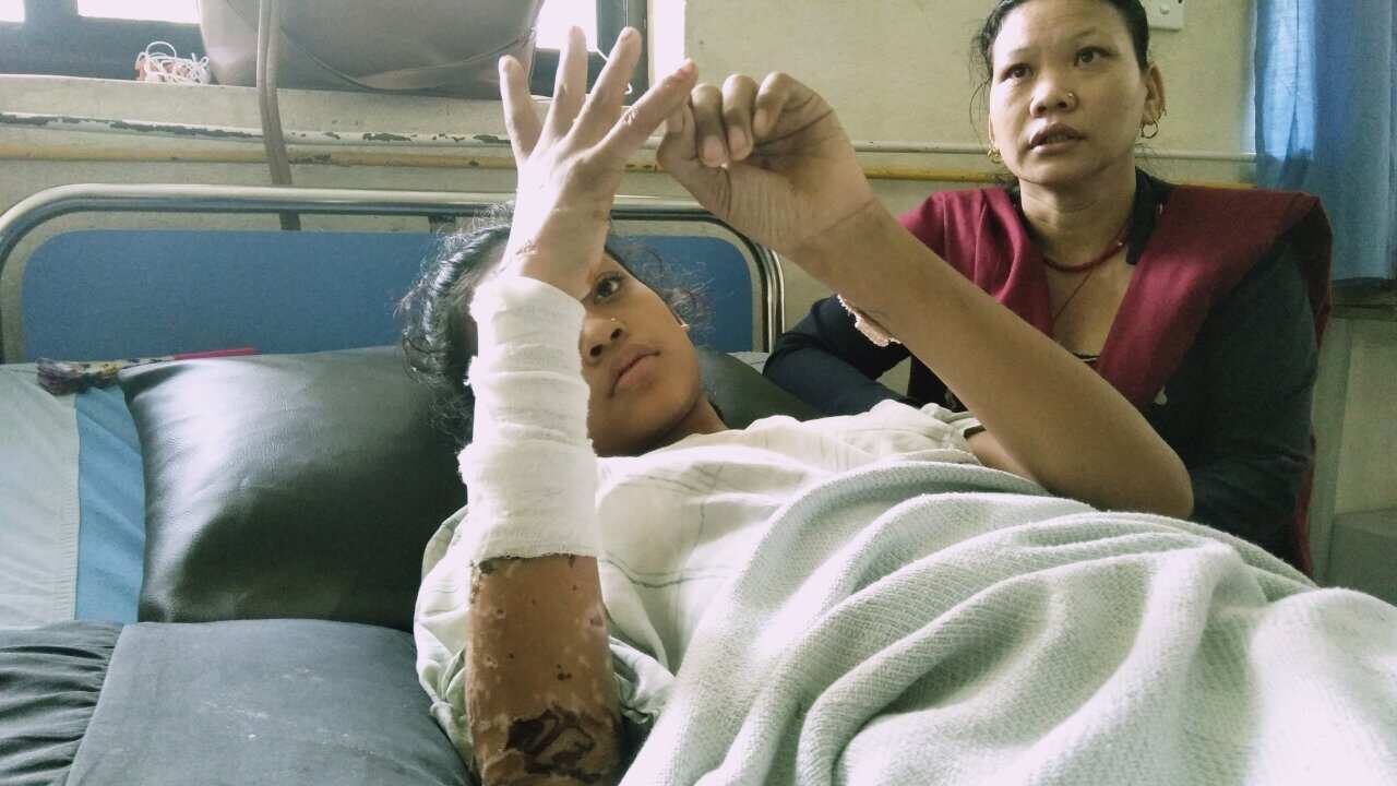 Acid attack victim Sushmita Das with her mother at hospital. Sushmita's sister Samjhana died after the attack.