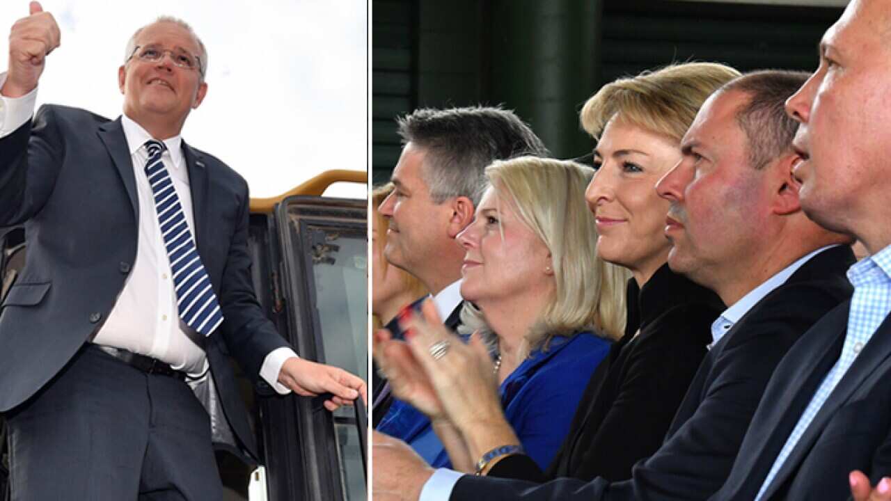 Prime Minister Scott Morrison climbs out of the cabin of a loader during a visit to the landscaping business (AAP)