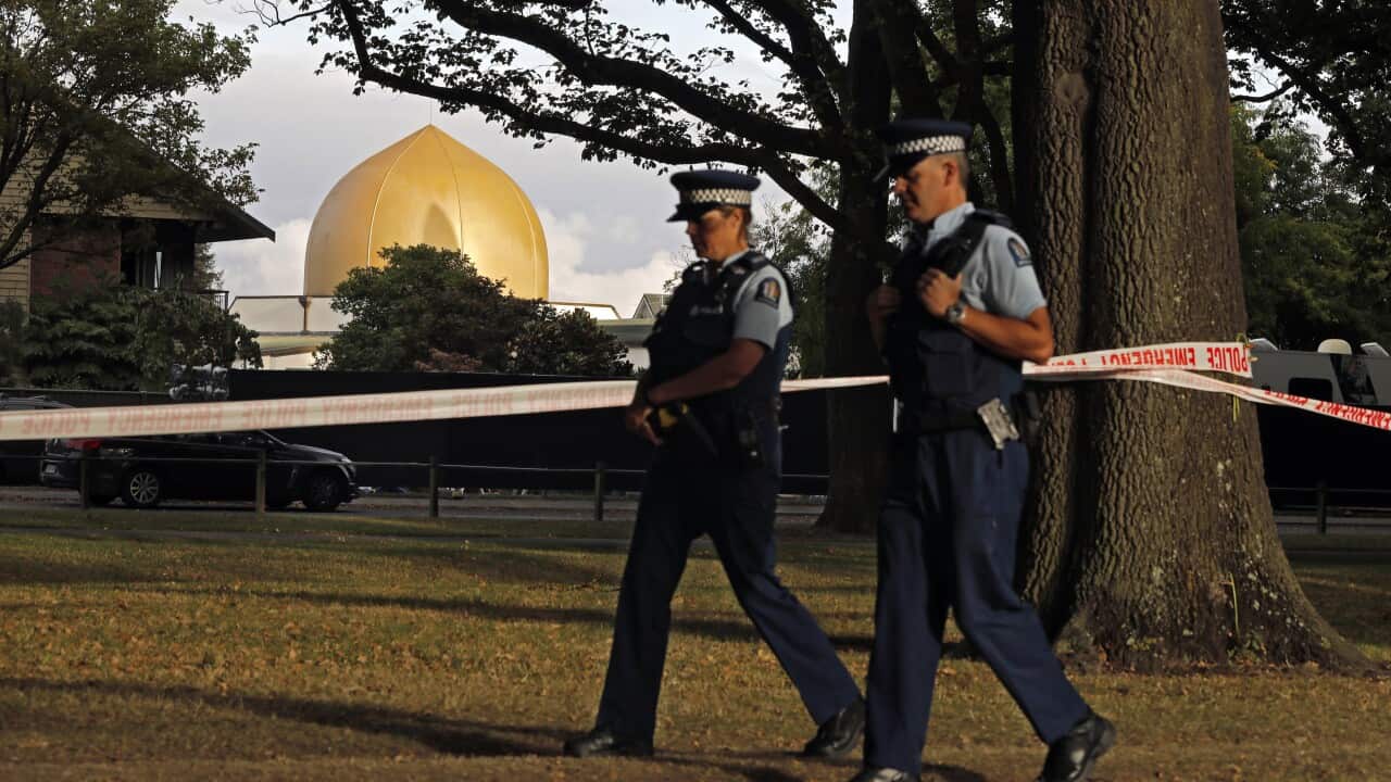 Police officers patrol at a park outside the Al Noor mosque in Christchurch