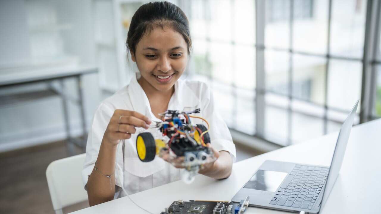 Female Pupil Building Robotic Car In Science Lesson