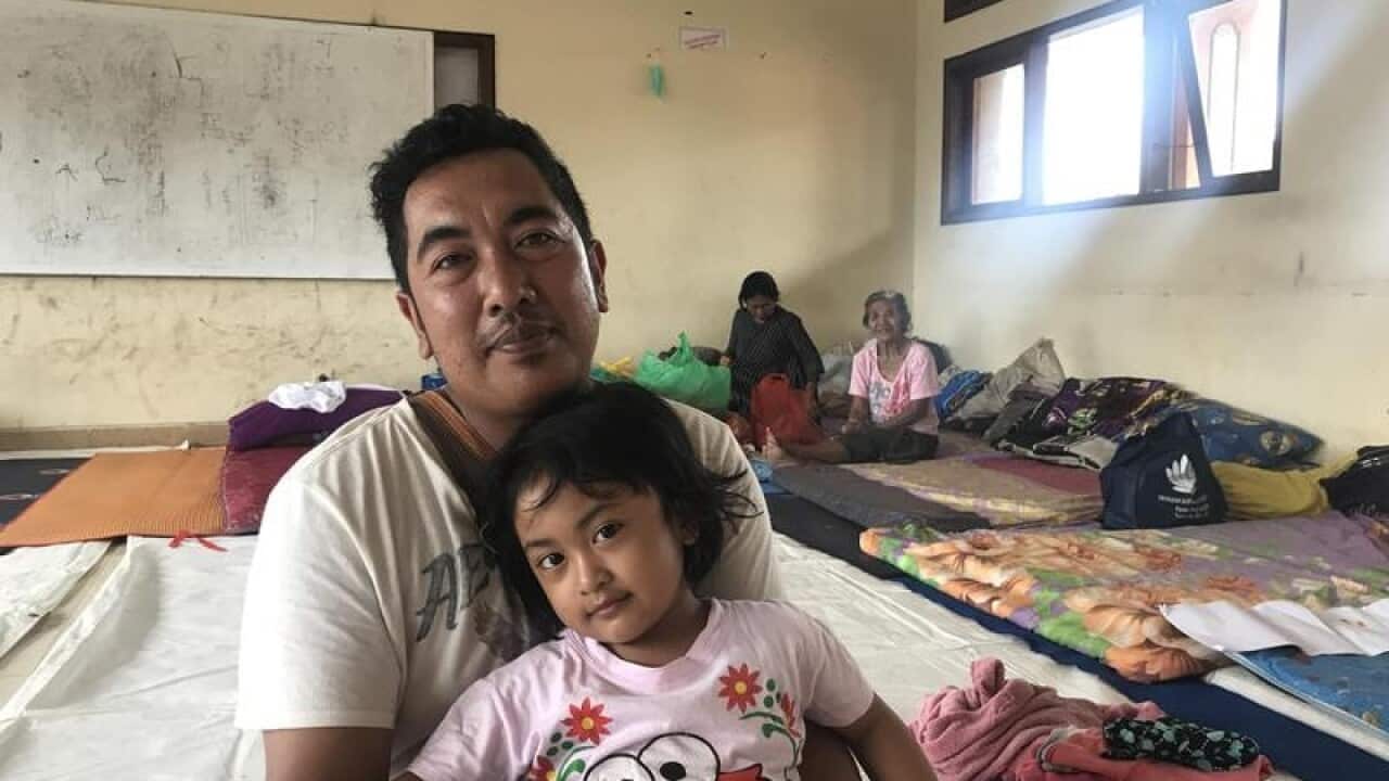 Komang Hendra and his daughter Putu have been displaced by Mt Agung