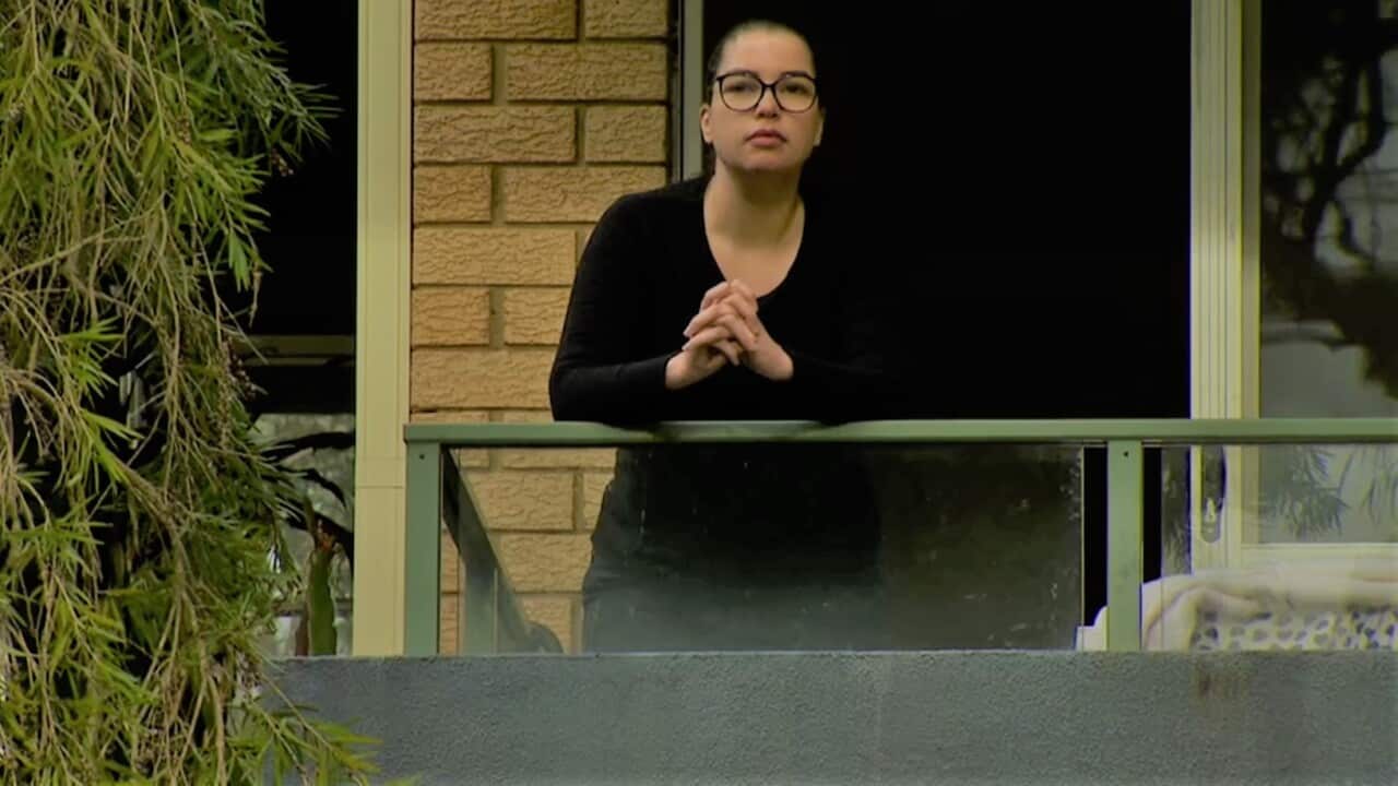 A pensive Renata Tavares Silva spending time on the balcony of her unit in Sydney.