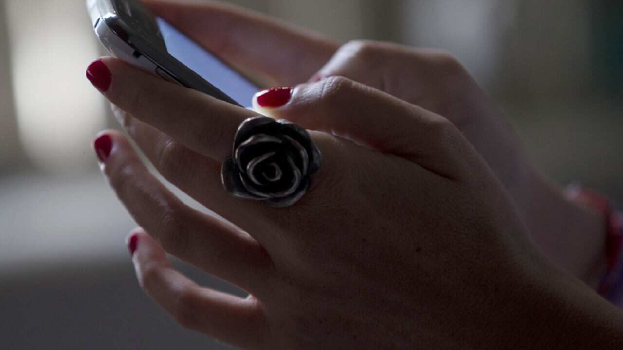A woman uses a smart phone.