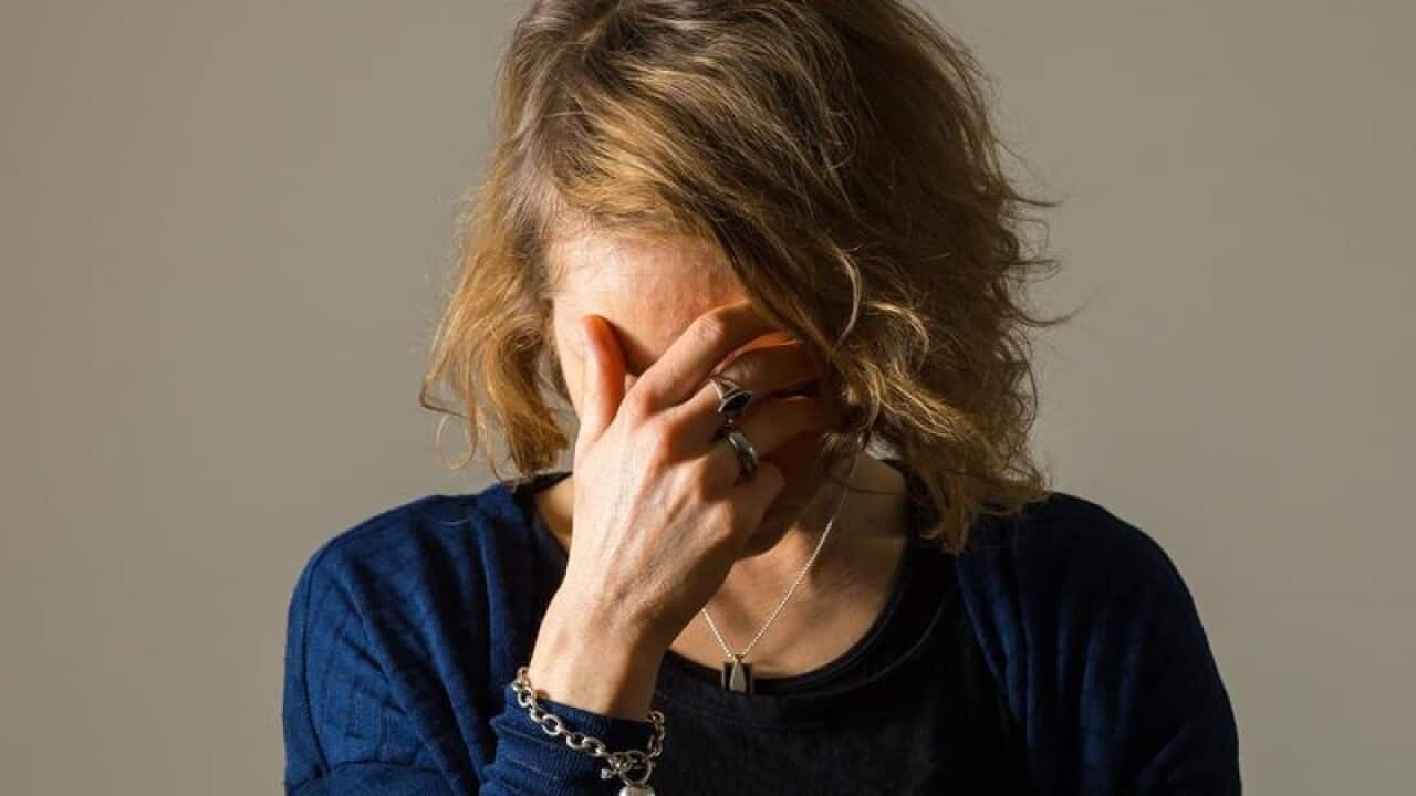 Woman with face in her hand