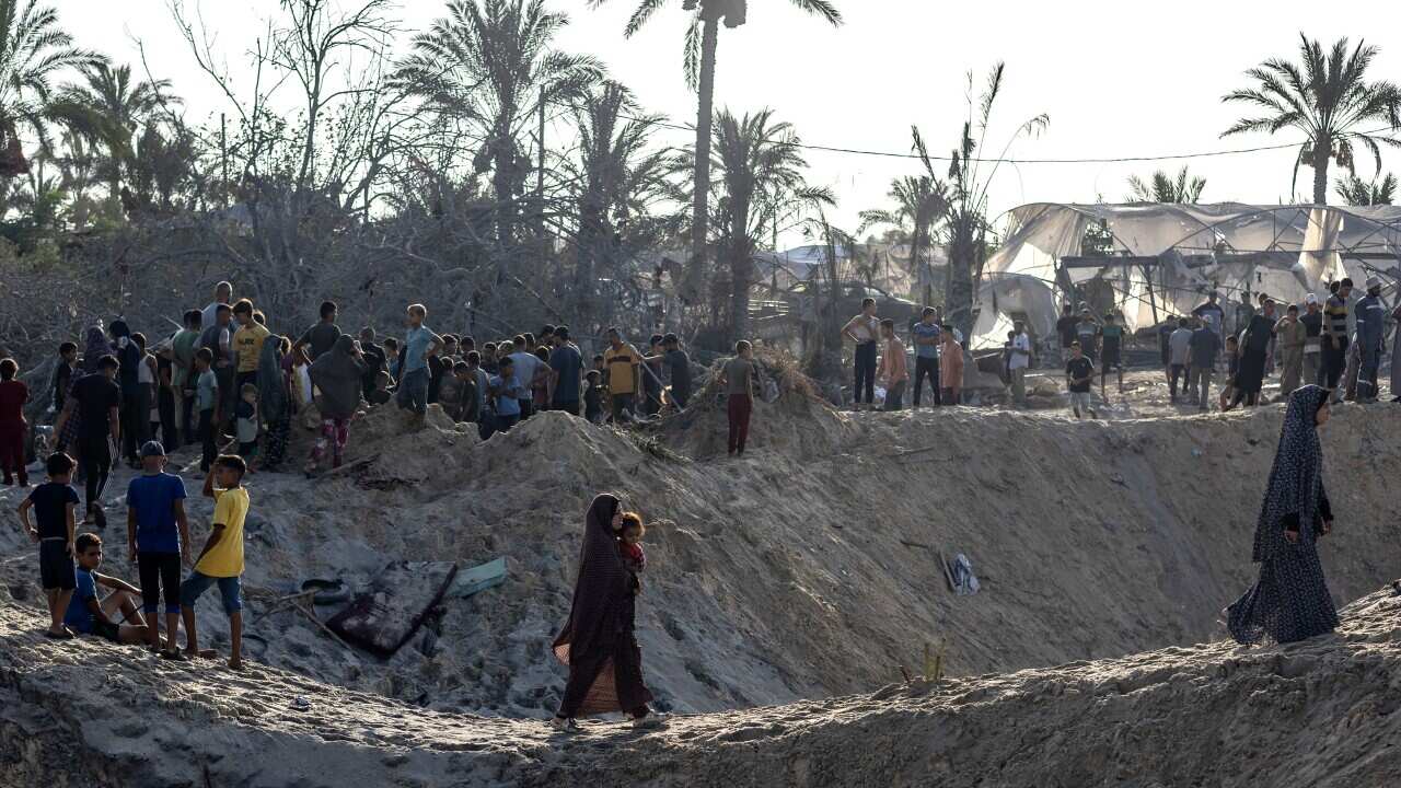 Palestinians search for missing people following Israeli airstrikes on a humanitarian zone.