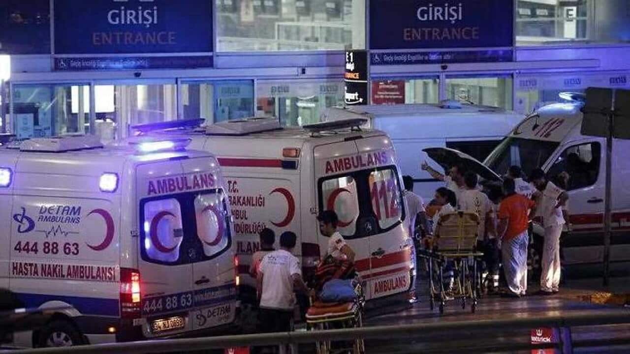 Medics wait for helping wounded people after a suicide bomb attack at Ataturk Airport in Istanbul, Turkey. (AAP)
