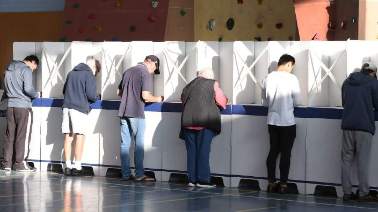 Tasmanians filling ballot forms