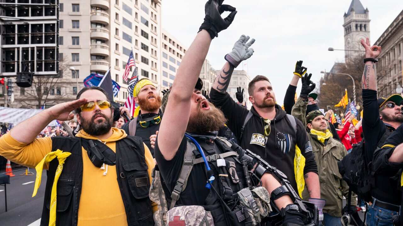 Members of the far-right group the Proud Boys gesture the 'white power' hand sign as they gather in Freedom Plaza, in Washington, DC, USA, 12 December 2020