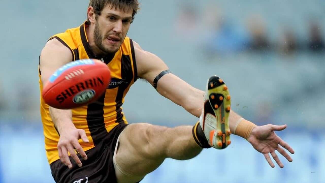 Grant Birchall of the Hawks kicks.