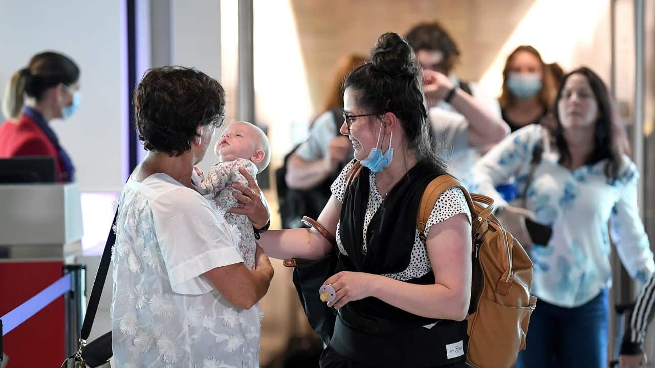Passengers are reunited with loved-ones after arriving on the first flight from Melbourne at the Brisbane Domestic Airport (AAP)