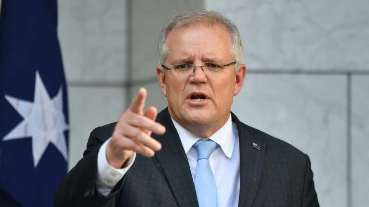 Prime Minister Scott Morrison talks to reporters.