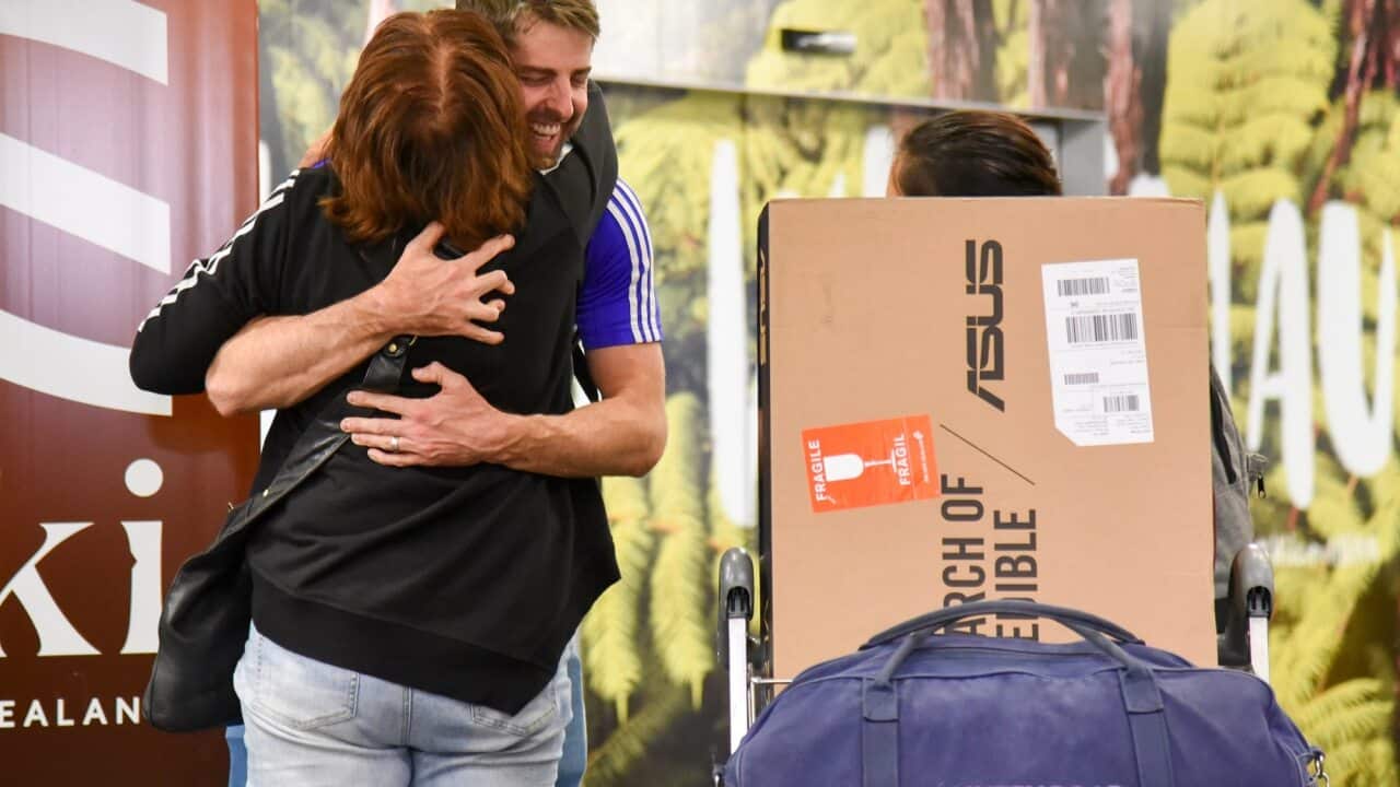 Families and loved ones embrace after landing on the first Air New Zealand flight to land in Wellington on 19 April 2021.