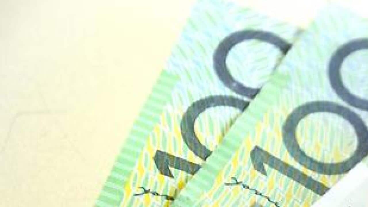 $100 Australian dollar notes pop out of a wallet with credit cards, pictured in Brisbane, Tuesday, Aug. 20, 2013. (AAP Image/Dan Peled) NO ARCHIVING