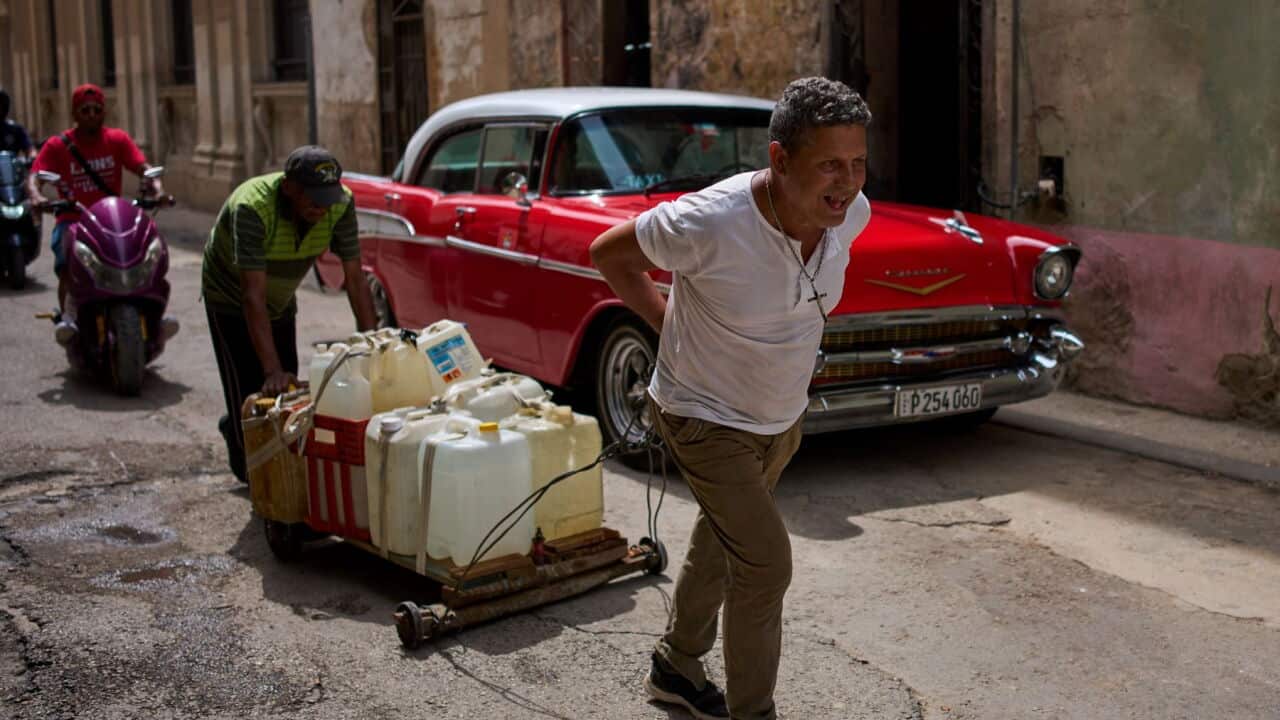 People transport containers of water in Havana (AP Photo-Ramon Espinosa).jpg