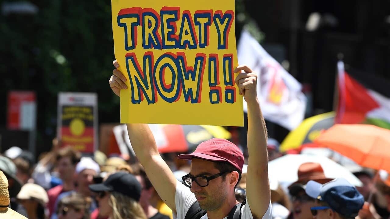 Protesters take part in an 'Invasion Day Rally' in Sydney.