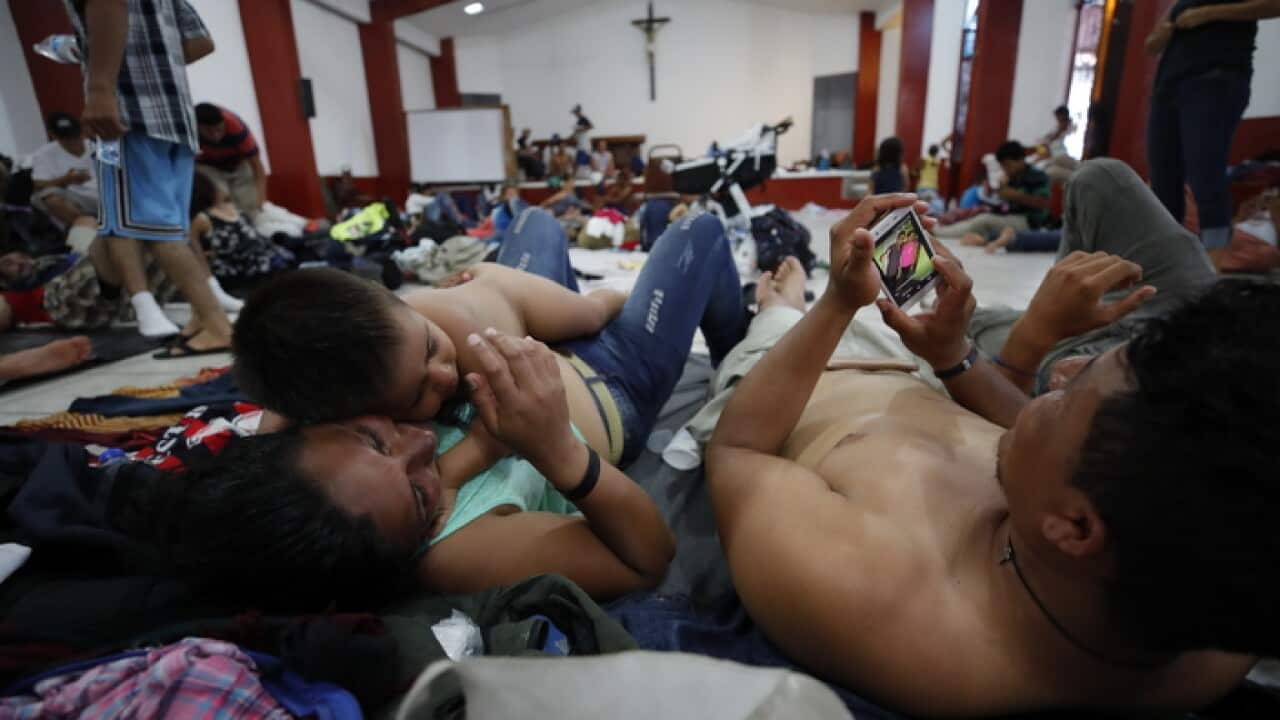 Migrants resting in a church in Huxtla, Mexico
