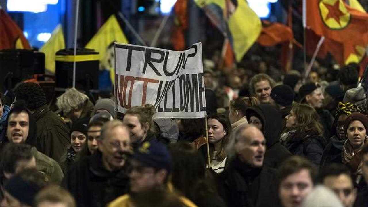 Protesters march during demonstration against upcoming Trump visit.